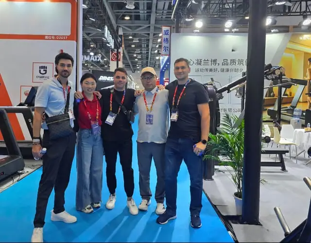 WDER Fitness manufacturing team standing inside commercial gym equipment workshop